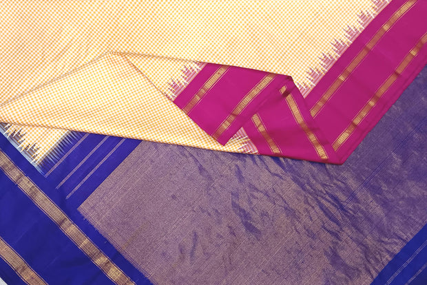 Handwoven Gadwal pure silk saree in cream & orange  in fine checks   and  a contrast pallu in blue .