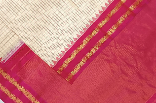 Handwoven Gadwal pure silk saree in cream  in fine checks   and  a contrast pallu in pink .