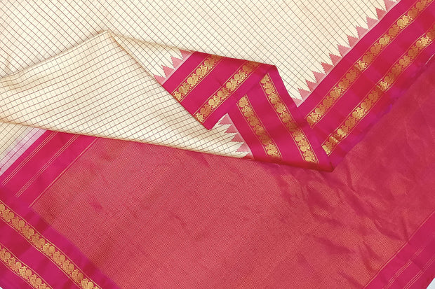 Handwoven Gadwal pure silk saree in cream  in fine checks   and  a contrast pallu in pink .