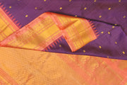 Handwoven Gadwal pure silk saree in wine in fine checks  with small motifs   and  a contrast pallu in peach .