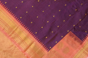 Handwoven Gadwal pure silk saree in wine in fine checks  with small motifs   and  a contrast pallu in peach .