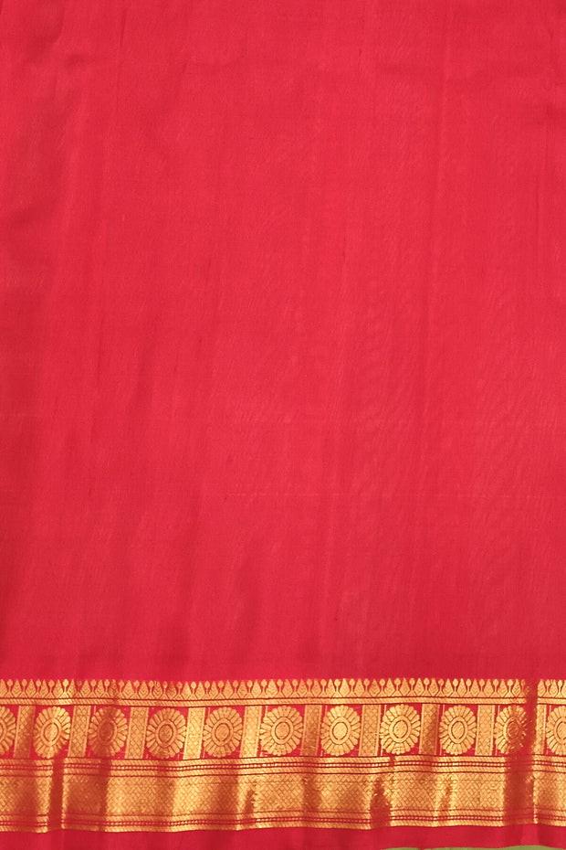 Handwoven Gadwal pure silk saree in  rama  green with  colourful  motifs on the body .