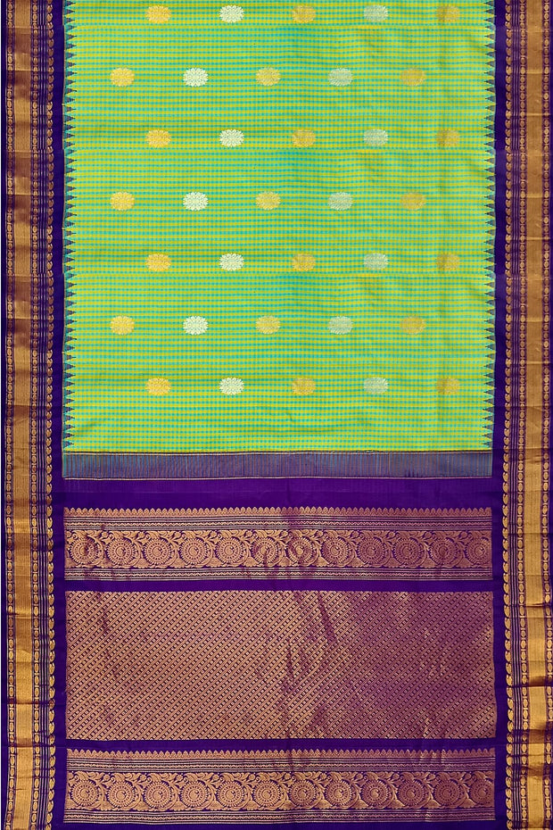 Handwoven Gadwal pure silk saree in fine checks in green & yellow  with gold & silver motifs all over the body.
