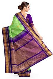Handwoven Gadwal pure silk saree in fine checks in green & yellow  with gold & silver motifs all over the body.