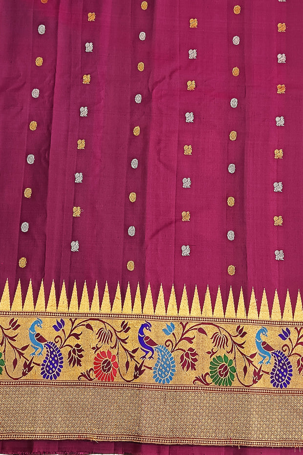 Handwoven Gadwal pure silk saree in bottle green with gold & silver motifs  all over the body.