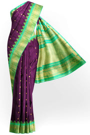 Handwoven Gadwal pure silk saree in wine with floral motifs on the body .