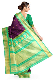 Handwoven Gadwal pure silk saree in wine with floral motifs on the body .