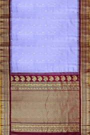 Handwoven Gadwal pure silk saree in lavender with floral motifs on the body .