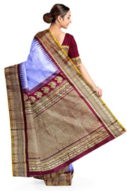 Handwoven Gadwal pure silk saree in lavender with floral motifs on the body .