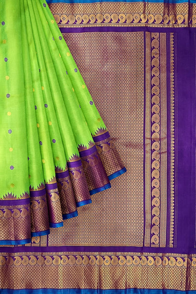 Handwoven Gadwal pure silk saree in green with floral motifs in gold & purple.