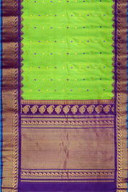 Handwoven Gadwal pure silk saree in green with floral motifs in gold & purple.