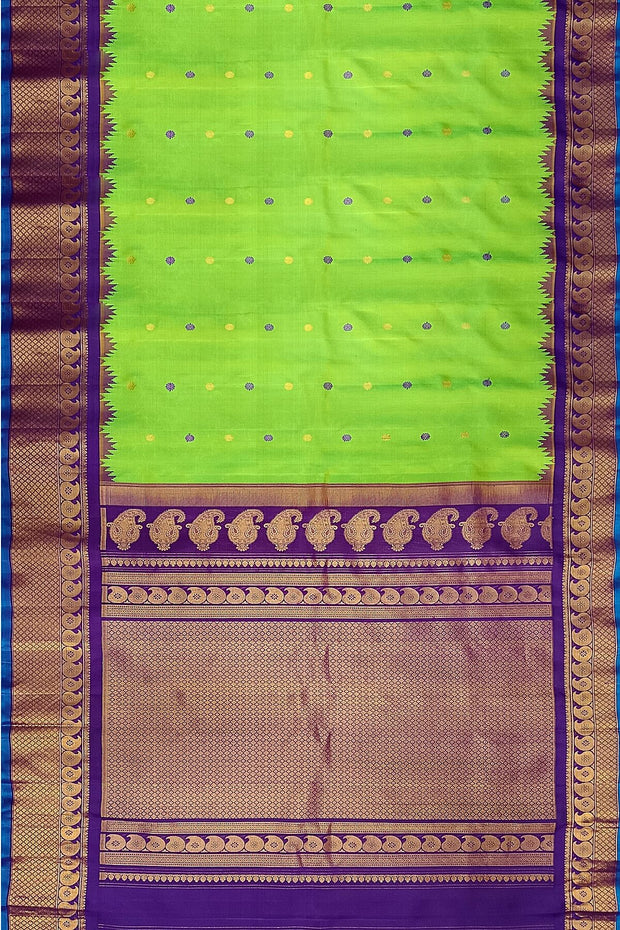 Handwoven Gadwal pure silk saree in green with floral motifs in gold & purple.