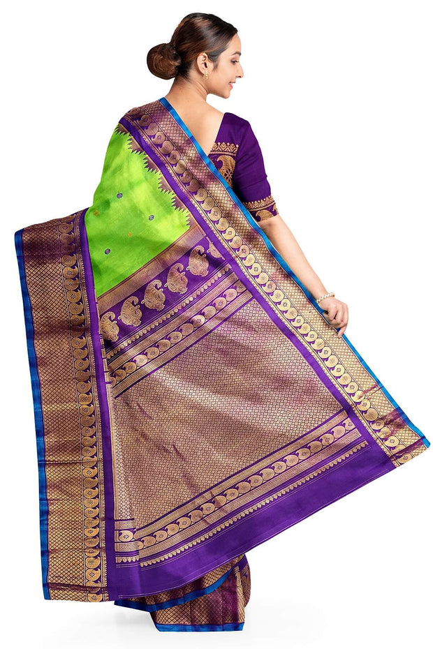 Handwoven Gadwal pure silk saree in green with floral motifs in gold & purple.
