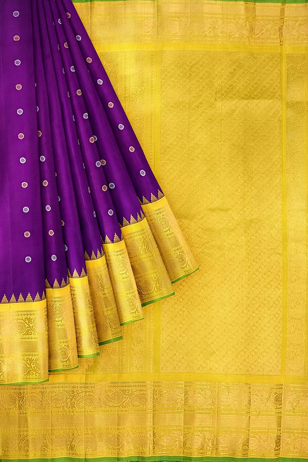 Handwoven Gadwal pure silk saree in purple with round motifs in gold & silver.