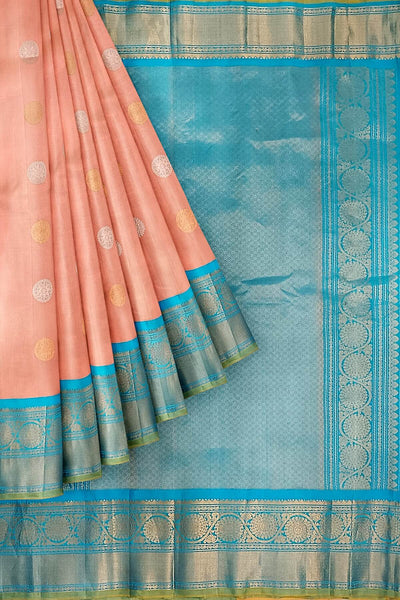Handwoven Gadwal pure silk saree in peach with floral motifs in gold & silver.