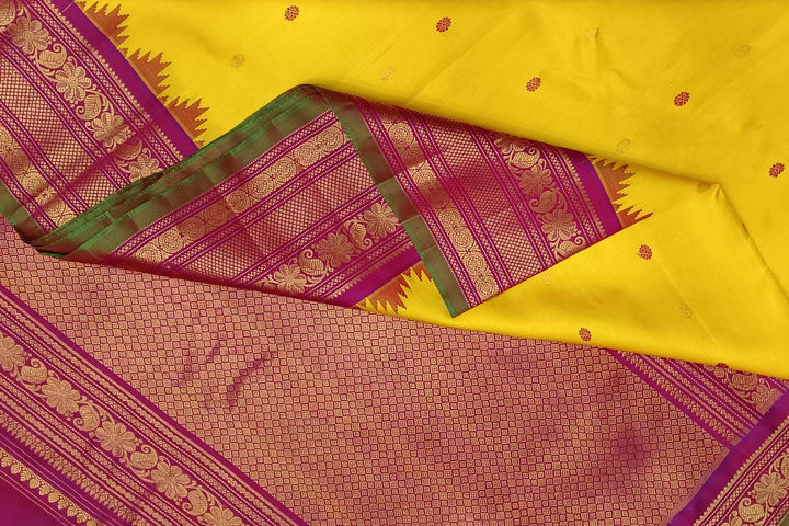 Handwoven Gadwal pure silk saree in yellow with floral   motifs in gold & magenta.