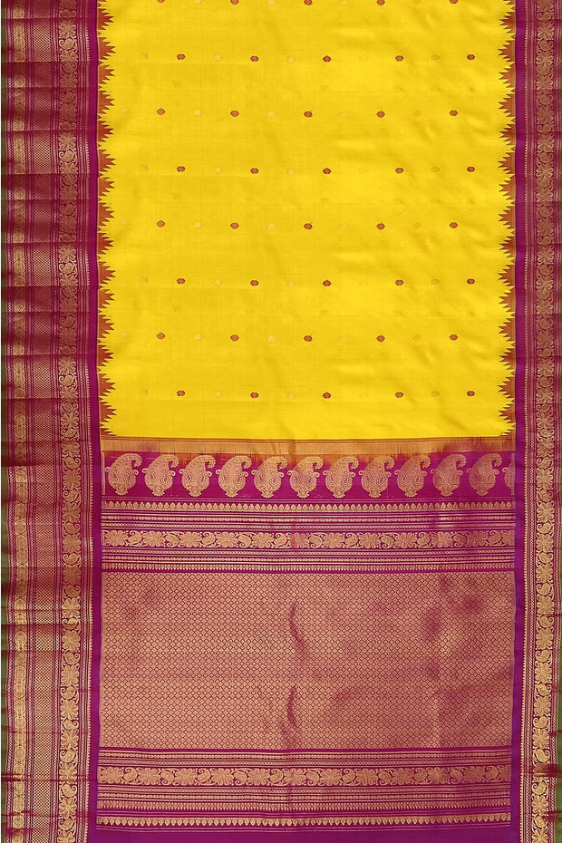 Handwoven Gadwal pure silk saree in yellow with floral   motifs in gold & magenta.