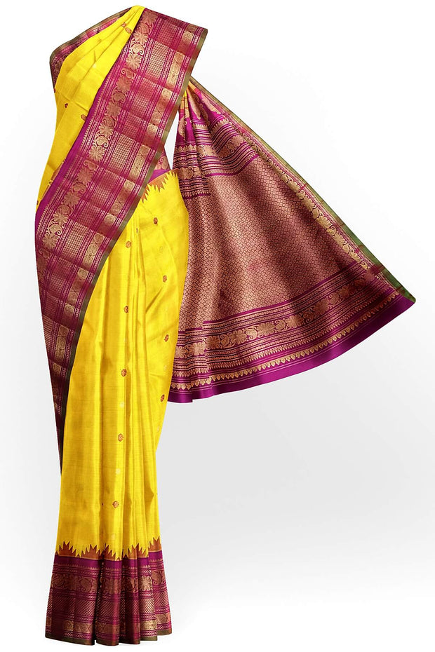 Handwoven Gadwal pure silk saree in yellow with floral   motifs in gold & magenta.