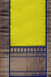 Handwoven Gadwal pure silk saree in lemon green with floral   motifs in gold & silver.
