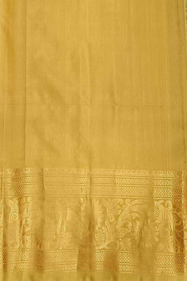 Handwoven Gadwal pure silk saree in purple with floral  motifs in gold .