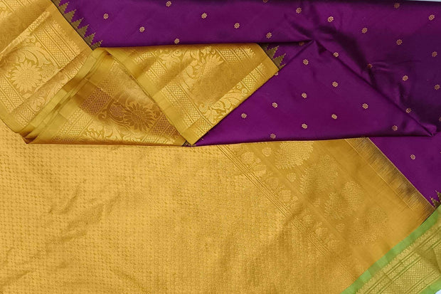 Handwoven Gadwal pure silk saree in purple with floral  motifs in gold .