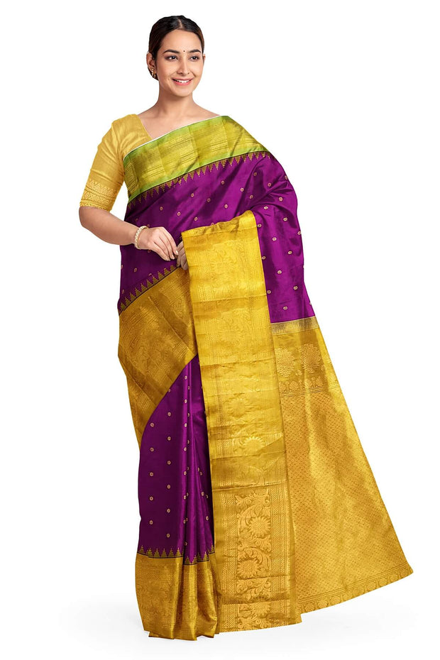Handwoven Gadwal pure silk saree in purple with floral  motifs in gold .