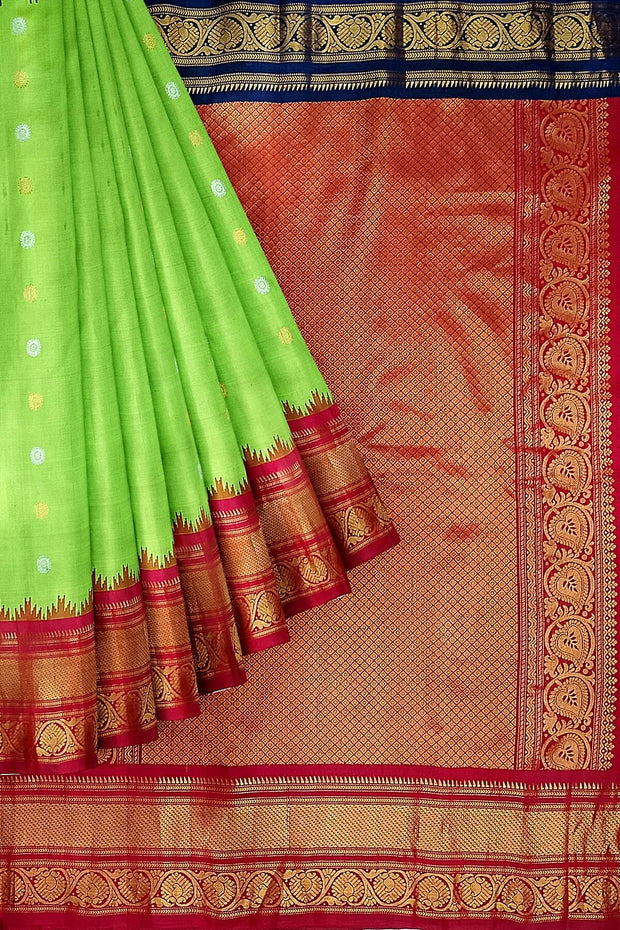 Handwoven Gadwal pure silk saree in green with floral  motifs in gold & silver .