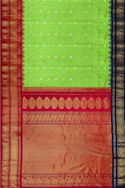 Handwoven Gadwal pure silk saree in green with floral  motifs in gold & silver .