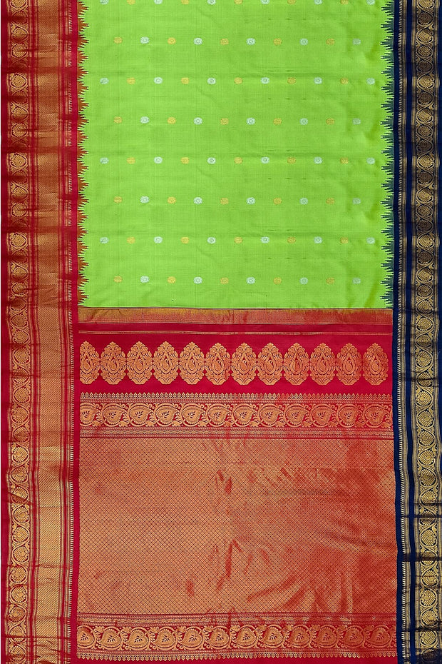 Handwoven Gadwal pure silk saree in green with floral  motifs in gold & silver .
