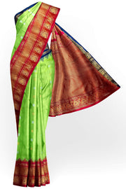 Handwoven Gadwal pure silk saree in green with floral  motifs in gold & silver .