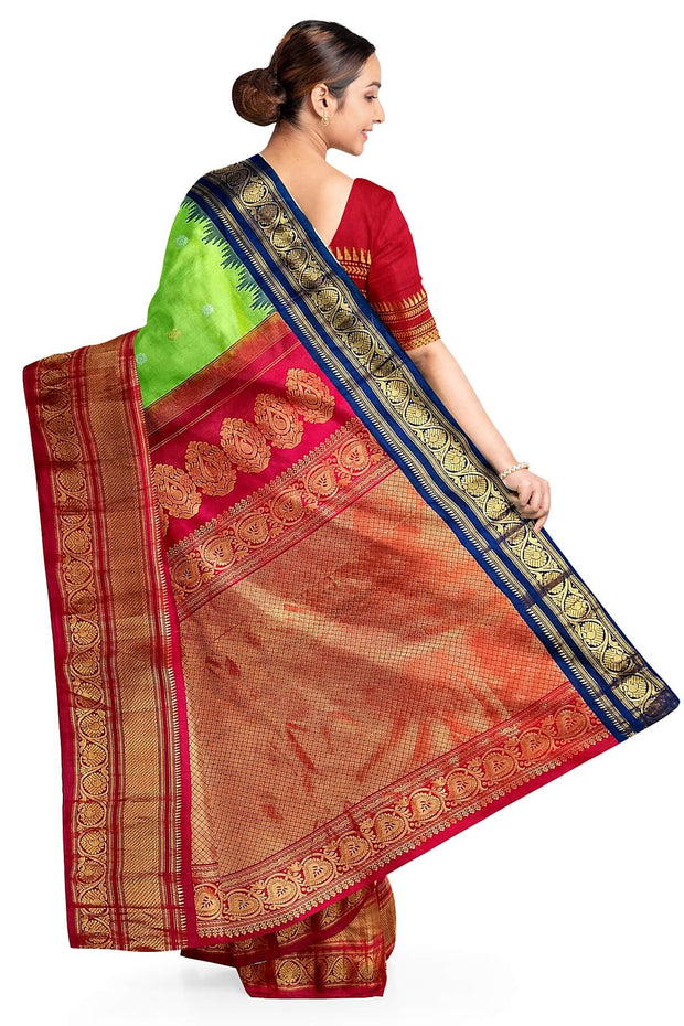 Handwoven Gadwal pure silk saree in green with floral  motifs in gold & silver .