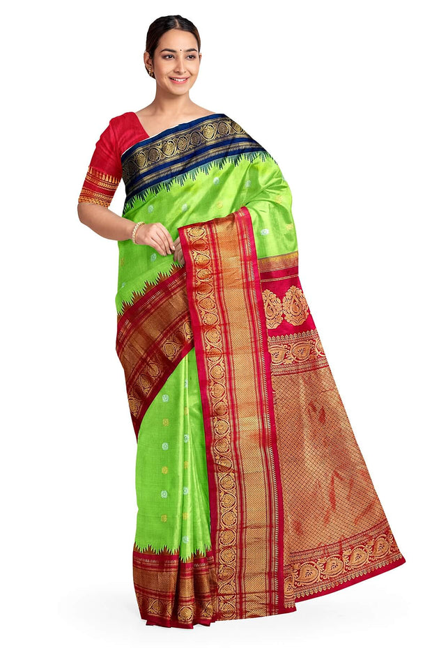 Handwoven Gadwal pure silk saree in green with floral  motifs in gold & silver .