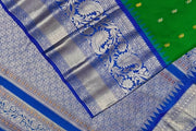 Gadwal pure silk saree in leaf green with  paisley  motifs in gold & silver.