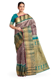 Gadwal pure silk saree in  chickoo with  peacock & floral motif in gold & silver.