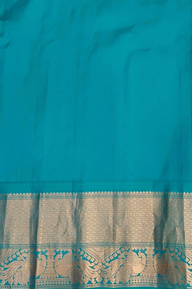 Gadwal pure silk saree in Berry blue with  peacock & floral motifs in gold .