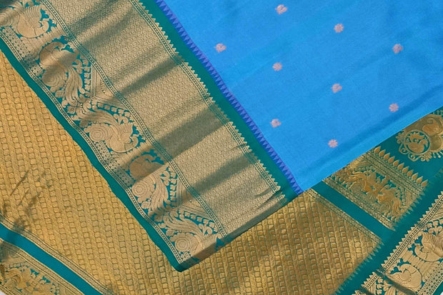Gadwal pure silk saree in Berry blue with  peacock & floral motifs in gold .