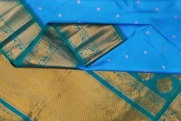 Gadwal pure silk saree in Berry blue with  peacock & floral motifs in gold .