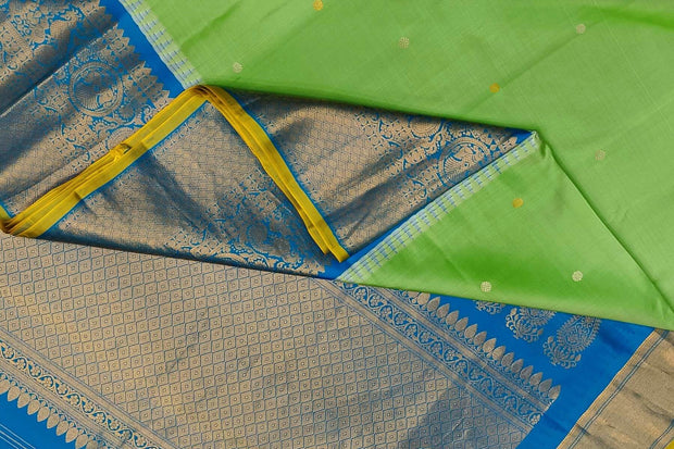 Gadwal pure silk saree in pista green with disc motifs in gold & silver .
