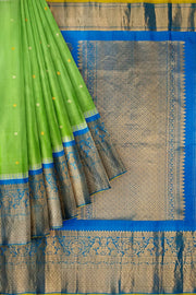 Gadwal pure silk saree in pista green with disc motifs in gold & silver .