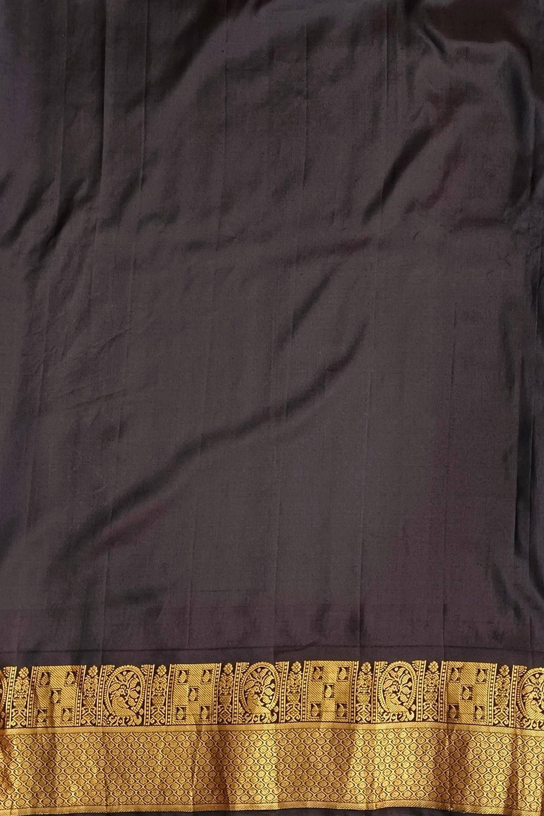 Gadwal pure silk saree in copper sulphate blue with  peacock &  disc  motif in gold.