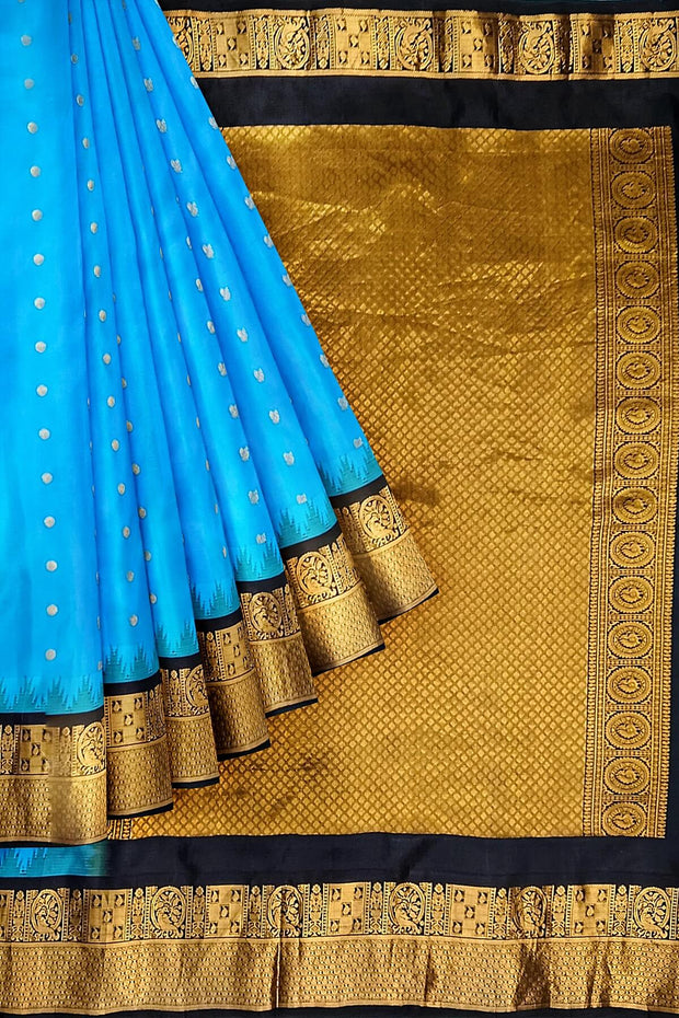 Gadwal pure silk saree in copper sulphate blue with  peacock &  disc  motif in gold.