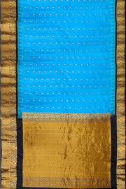 Gadwal pure silk saree in copper sulphate blue with  peacock &  disc  motif in gold.