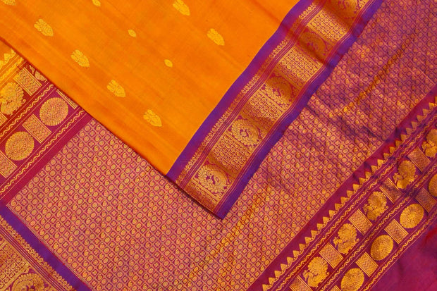 Handwoven Gadwal pure silk saree in mustard with small buttis on the body .