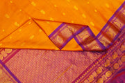 Handwoven Gadwal pure silk saree in mustard with small buttis on the body .