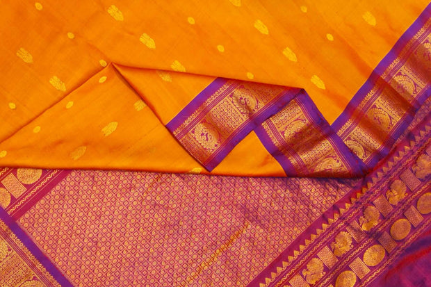Handwoven Gadwal pure silk saree in mustard with small buttis on the body .