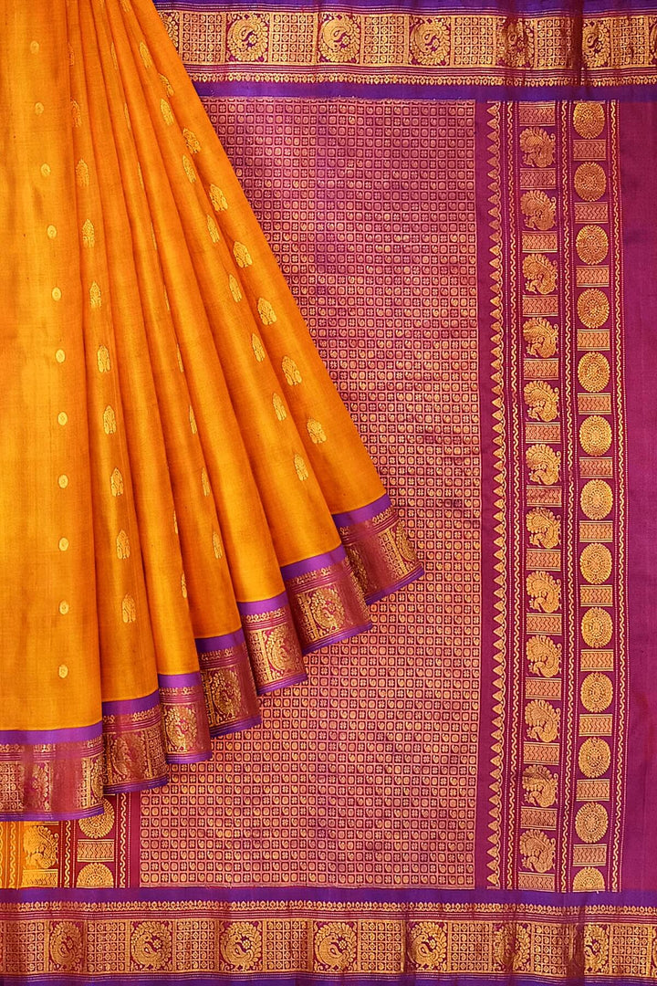 Handwoven Gadwal pure silk saree in mustard with small buttis on the body .