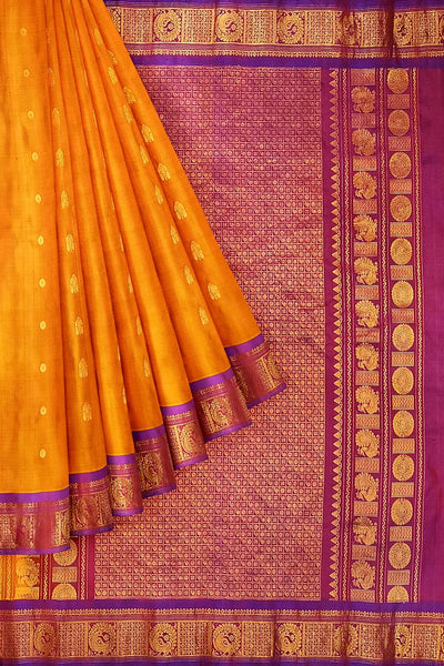 Handwoven Gadwal pure silk saree in mustard with small buttis on the body .