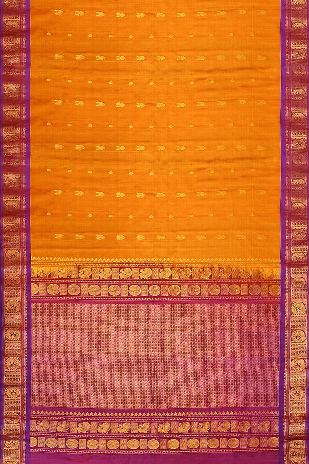 Handwoven Gadwal pure silk saree in mustard with small buttis on the body .