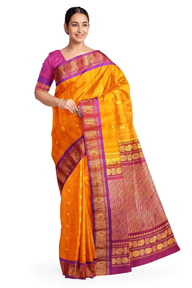 Handwoven Gadwal pure silk saree in mustard with small buttis on the body .