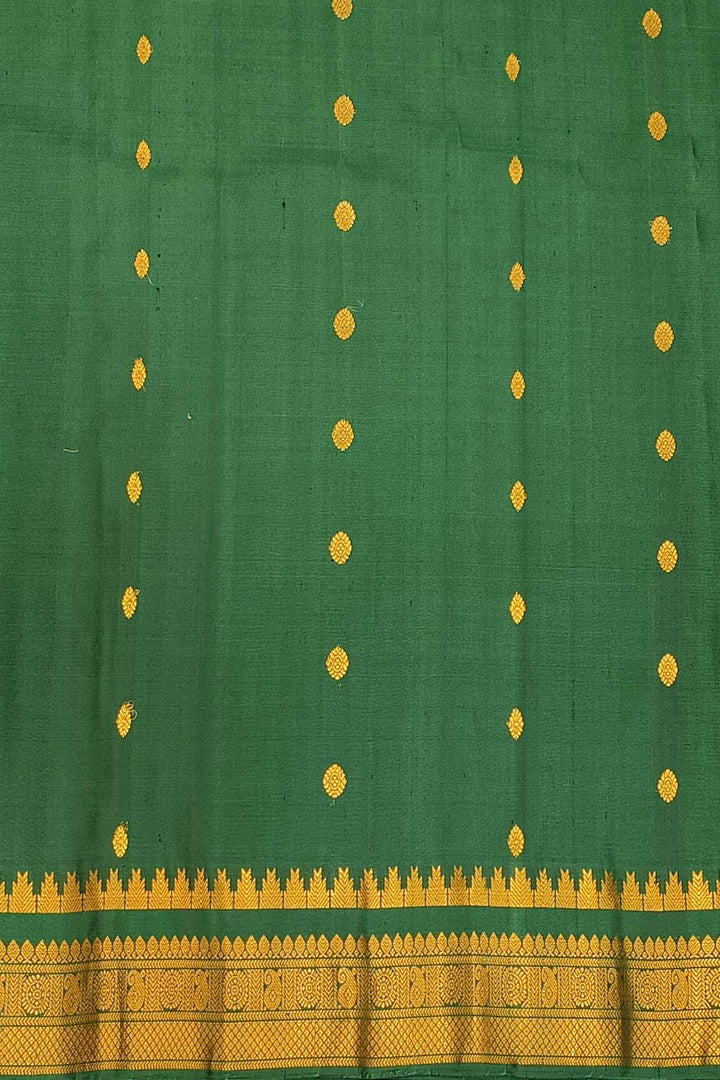 Handwoven Gadwal pure silk saree in  wine with small buttis on the body .